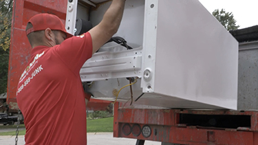 Junk King placing item into van.